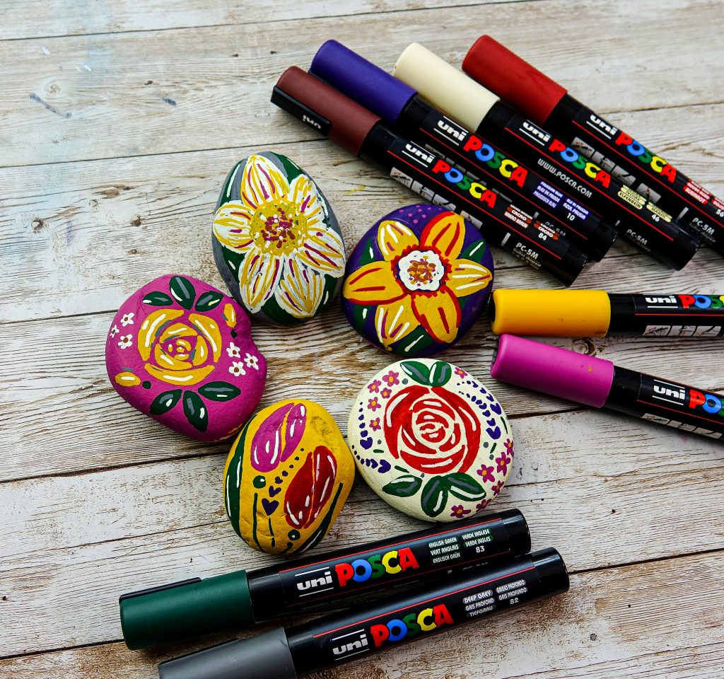 Decorate stones with spring flower designs in POSCA
